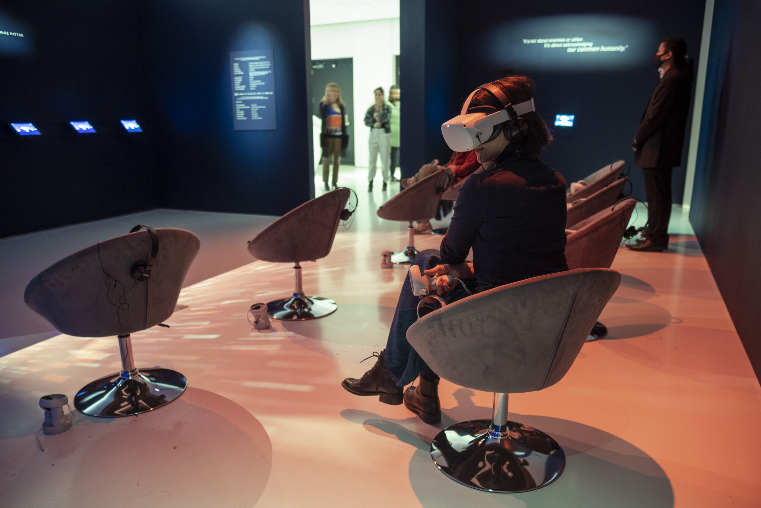 A museumgoer wears a VR headset at the On the Morning You Wake exhibit. Photo credit: Nate Dorr.